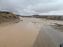 Water floods over State Route 190 east of Olancha on August 5, 2022.
