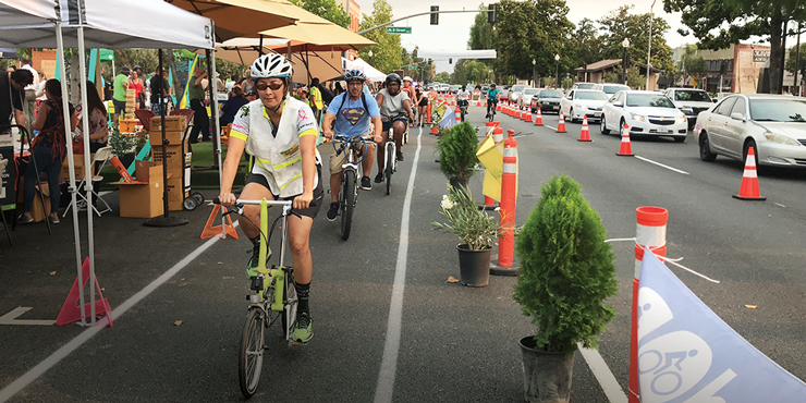 Photo of numerous cyclists in a bike lane during a street event