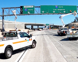 Photo thumbnail of Caltrans maintenance crews working on a nearly deserted Interstate 5 freeway in Los Angeles