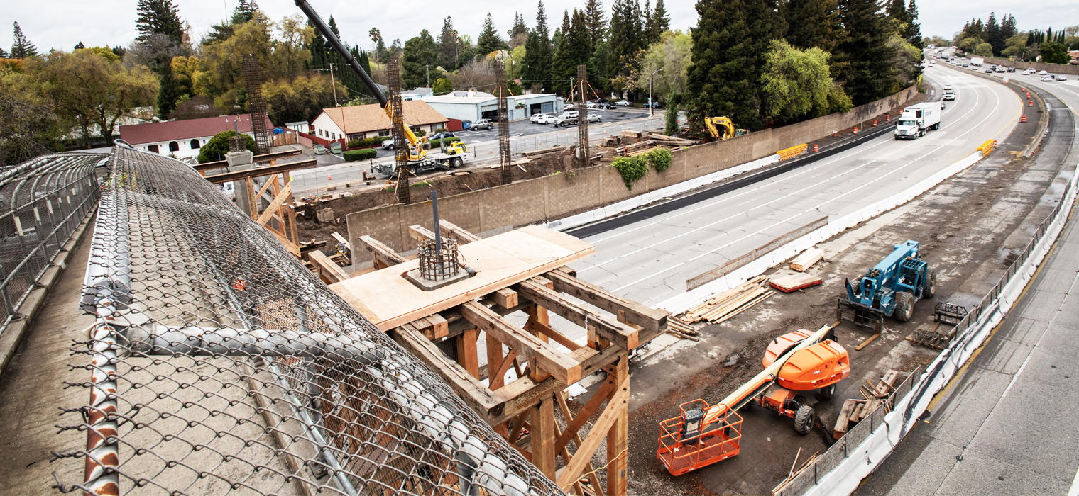 Photo taken from a pedestrian overcrossing looking down on construction site, taken during the I-5 Corridor Enhancement Project during March 2020.
